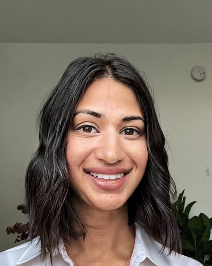 Sonika, founder of Studio8 Web Co, smiling in a white shirt